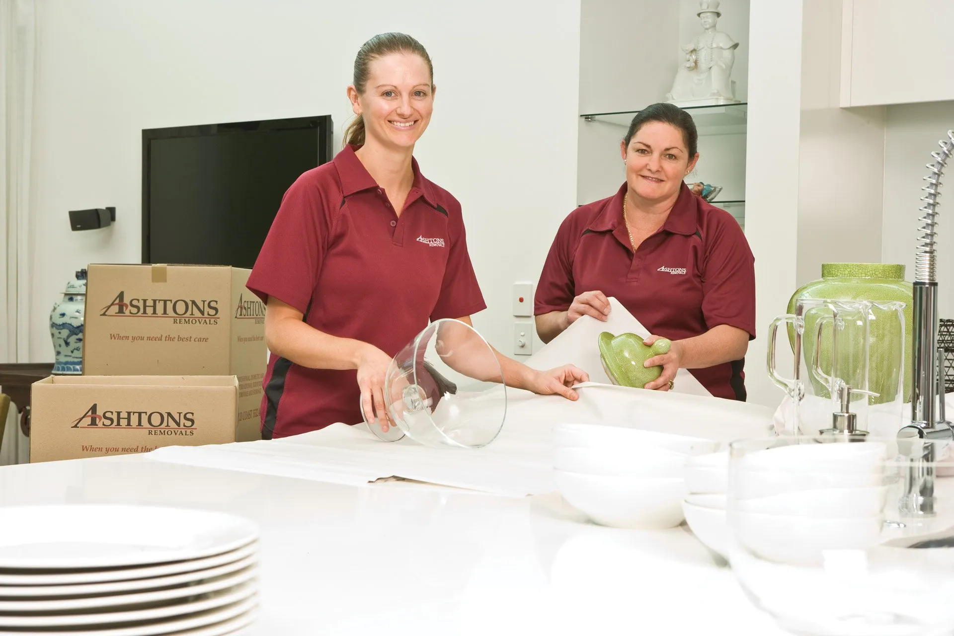 Ashton’s packing crew carefully wrapping kitchenware before a move