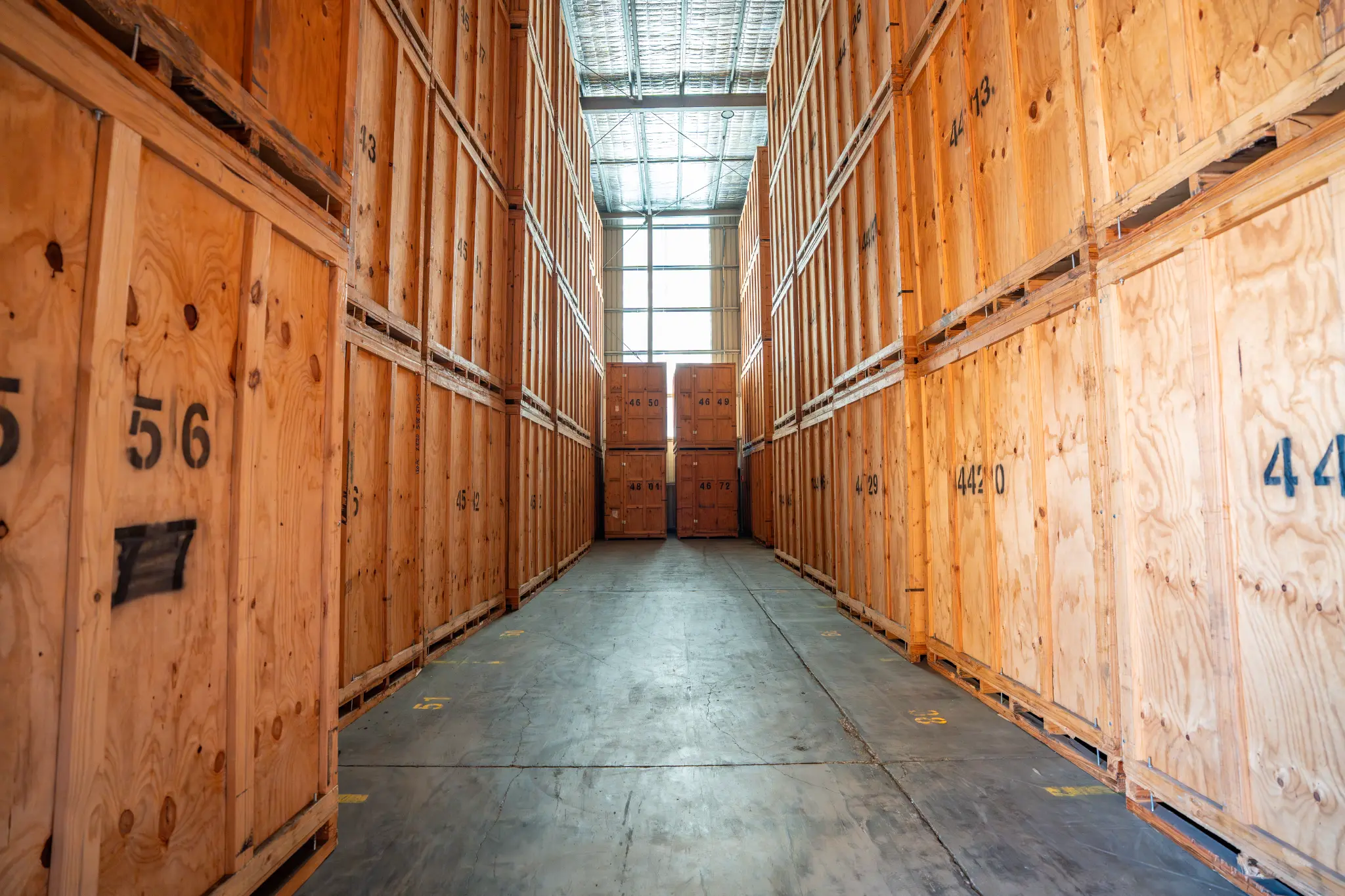 Aisle of timber storage modules inside an indoor warehouse